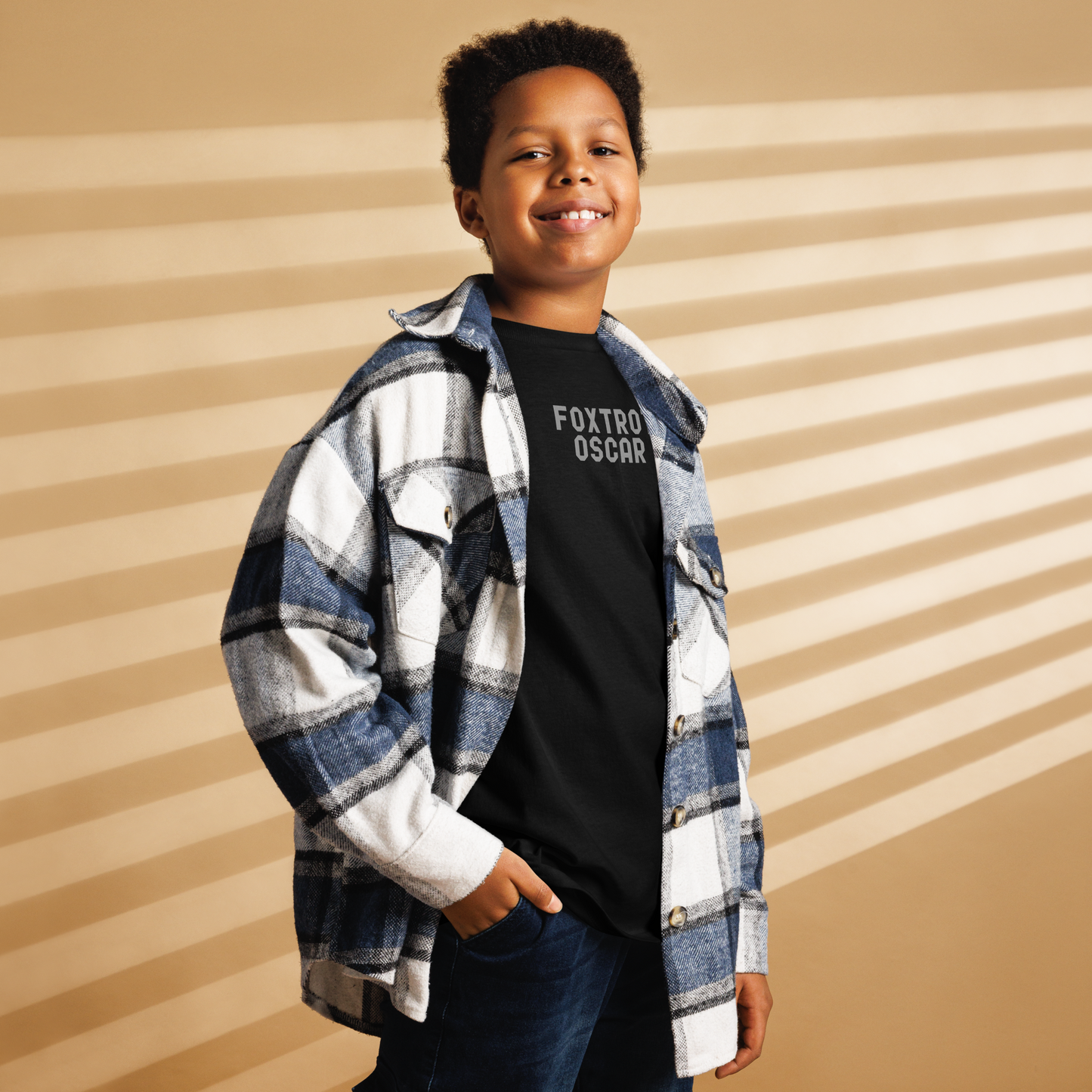 "Foxtrot Oscar" printed on a black youth classic tee worn by a male also wearing a jacket