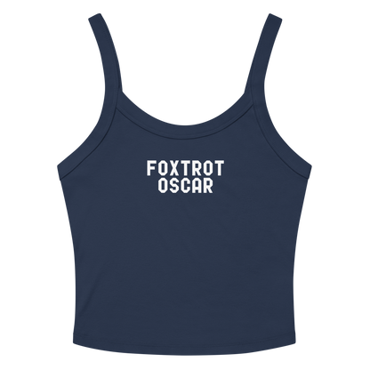 "Foxtrot Oscar" printed on a solid navy blend women's micro-rib tanktop laying on a flat surface amongst sunglasses and shorts