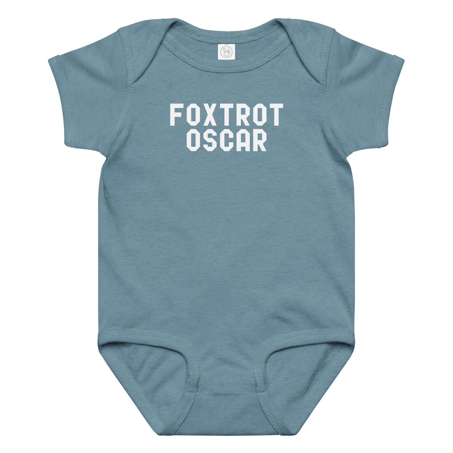 "Foxtrot Oscar" printed on a vintage indigo baby jersey bodysuit laying on a flat surface amongst other clothes