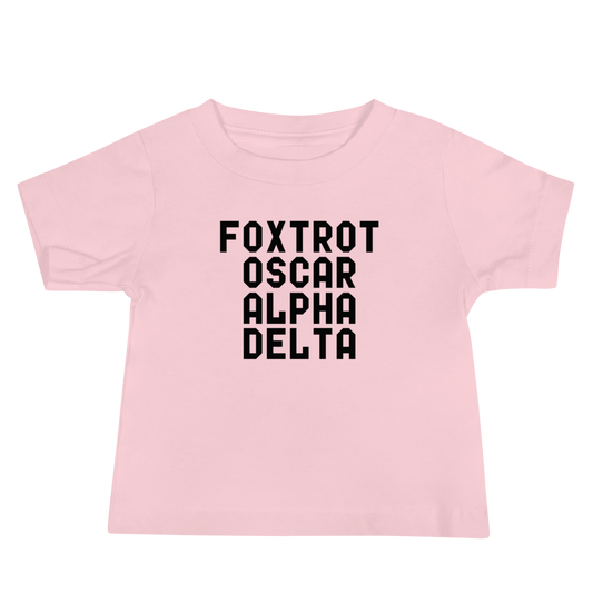 "Foxtrot Oscar Alpha Delta" printed on a pink baby jersey short sleeve tee laying on a flat surface