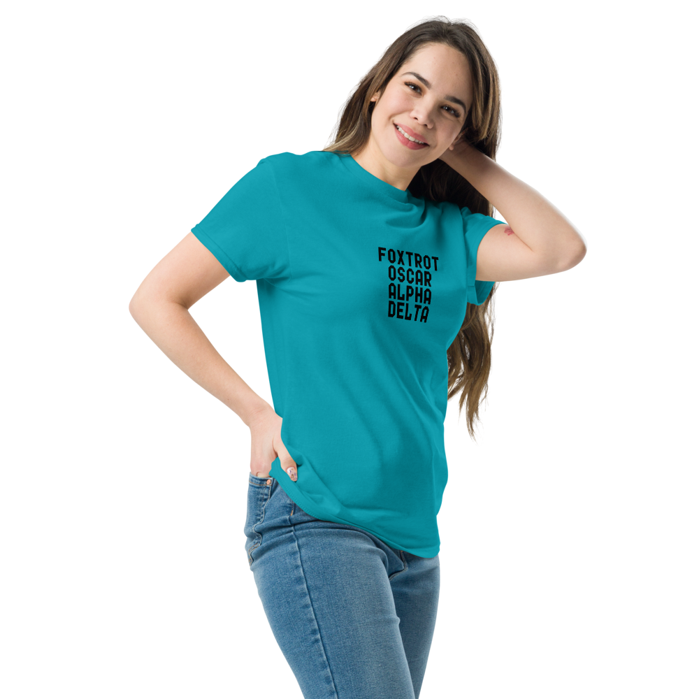 "Foxtrot Oscar Alpha Delta" printed on a tropical blue unisex classic tee worn by a female