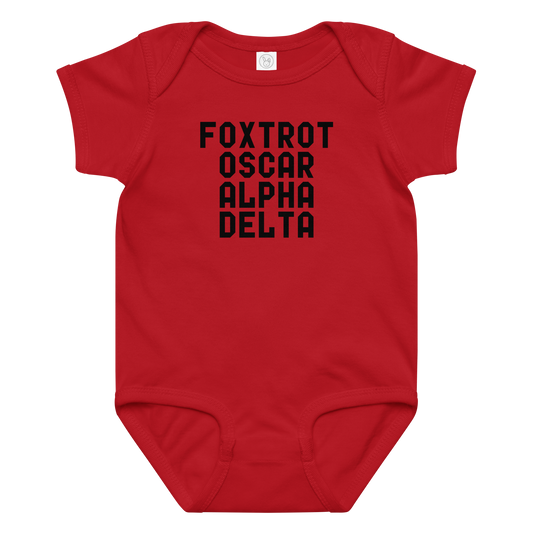 "Foxtrot Oscar Alpha Delta" printed on a red baby jersey bodysuit laying on a flat surface amongst other clothes