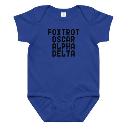 "Foxtrot Oscar Alpha Delta" printed on a royal baby jersey bodysuit laying on a flat surface amongst other clothes
