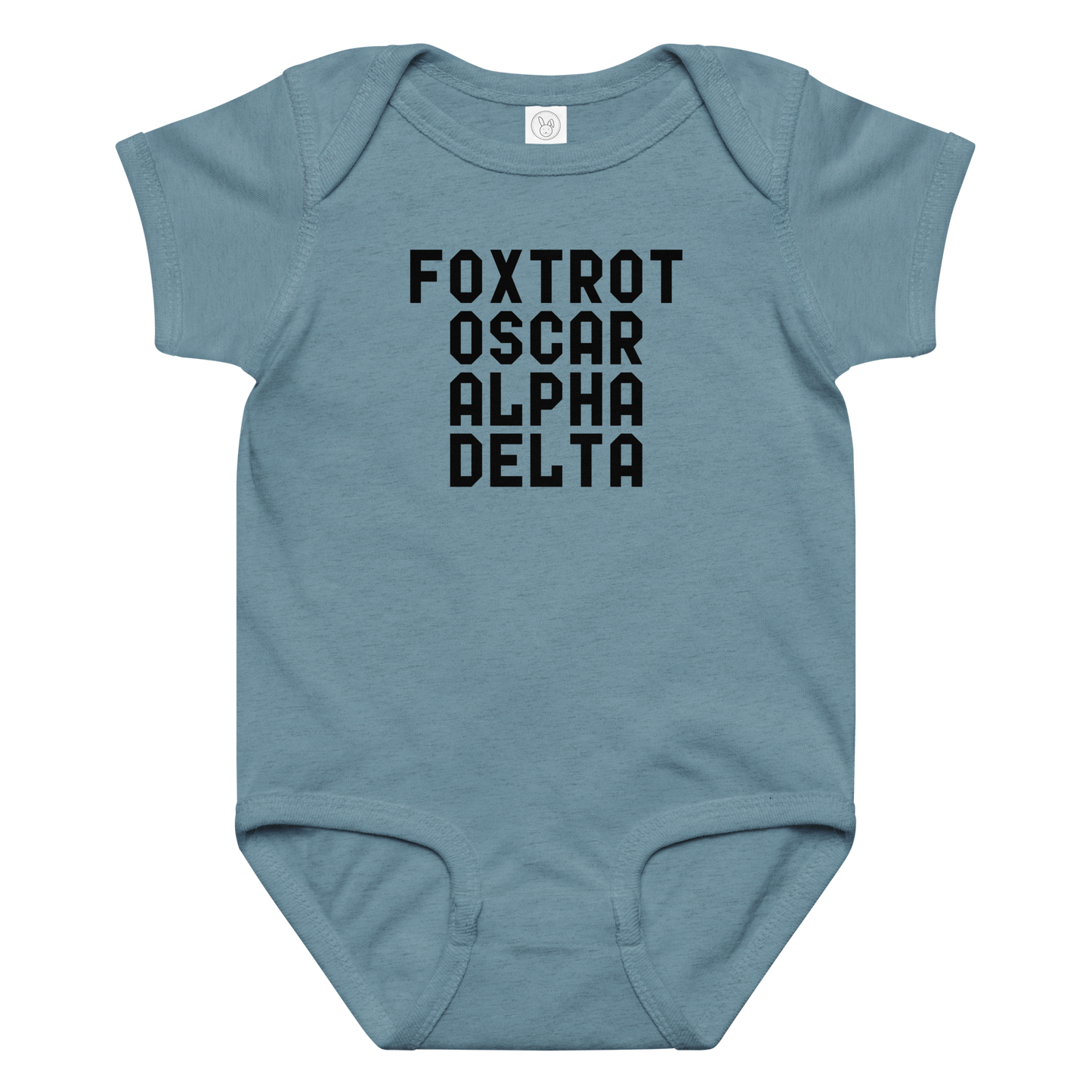 "Foxtrot Oscar Alpha Delta" printed on a vintage indigo baby jersey bodysuit laying on a flat surface amongst other clothes