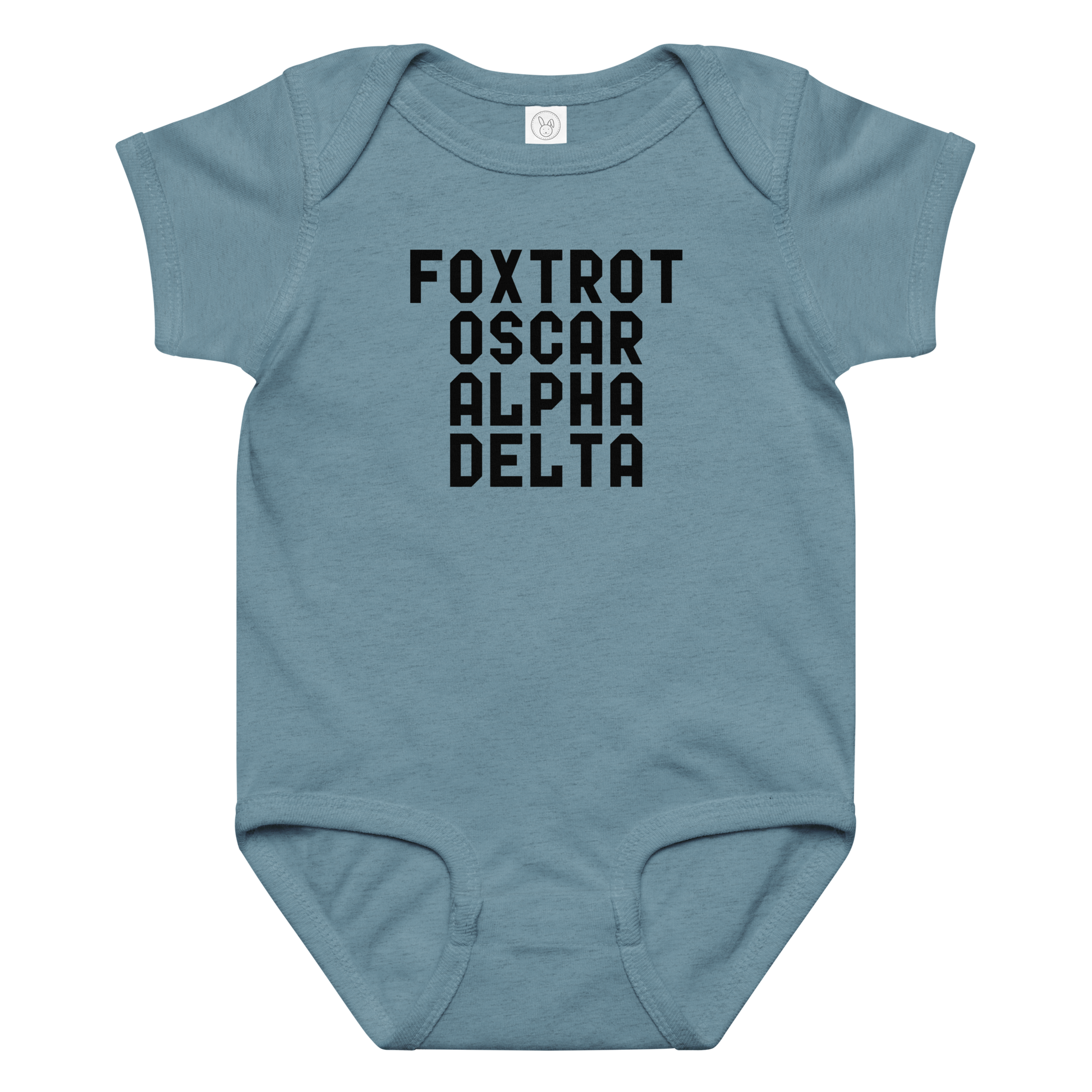 "Foxtrot Oscar Alpha Delta" printed on a vintage indigo baby jersey bodysuit laying on a flat surface amongst other clothes