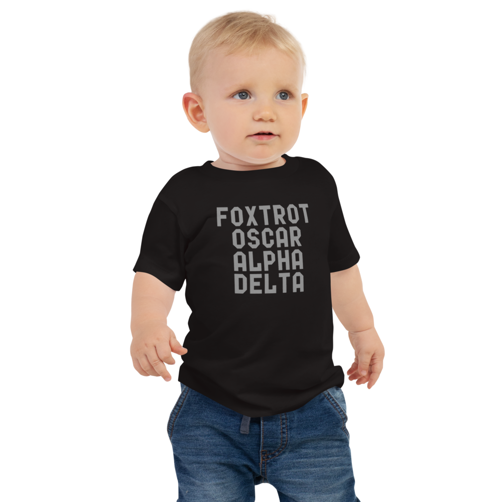 "Foxtrot Oscar Alpha Delta" printed on a black baby jersey short sleeve tee worn by a male