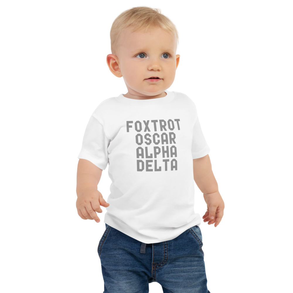 "Foxtrot Oscar Alpha Delta" printed on a white baby jersey short sleeve tee worn by a male