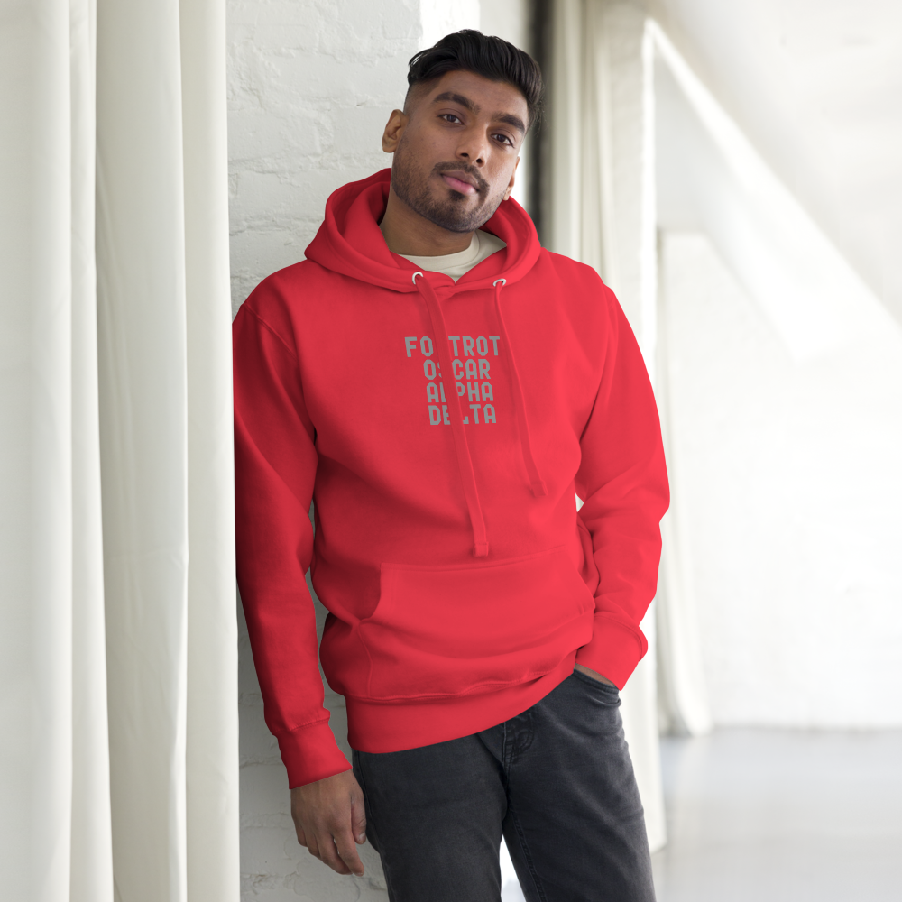 "Foxtrot Oscar Alpha Delta" printed on a team red unisex hoodie worn by a male