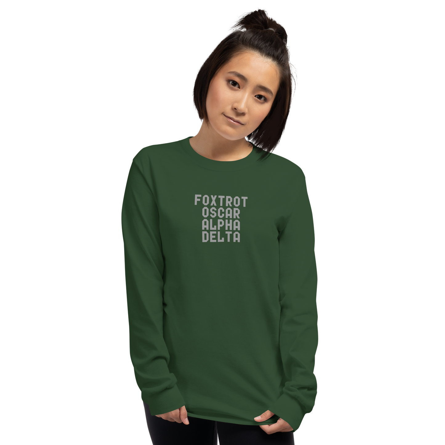 "Foxtrot Oscar Alpha Delta" printed on a forest green men's long sleeve shirt worn by a female