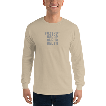 "Foxtrot Oscar Alpha Delta" printed on a sand men's long sleeve shirt worn by a male