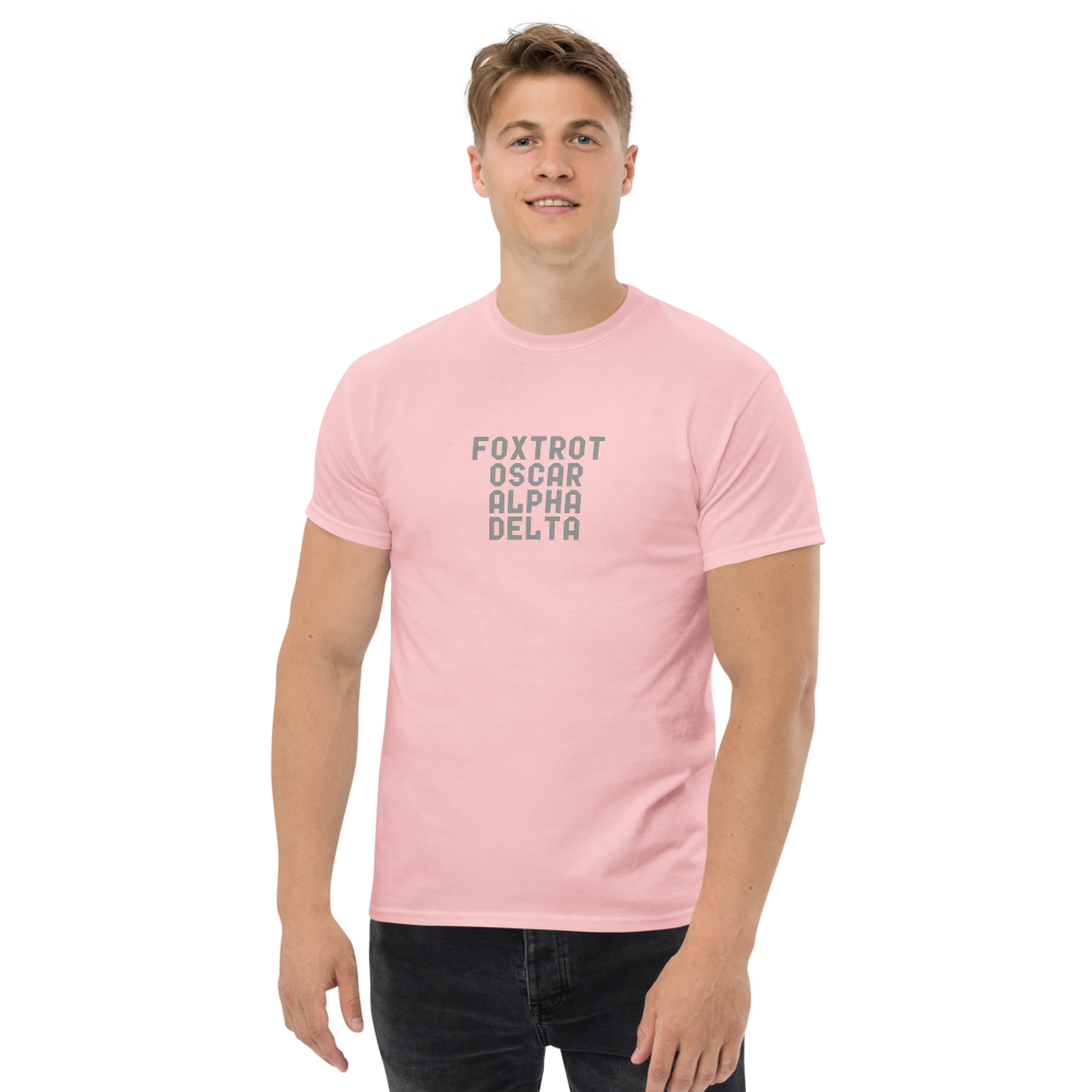 "Foxtrot Oscar Alpha Delta" printed on a light pink unisex classic tee worn by a male