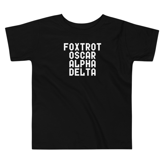 "Foxtrot Oscar Alpha Delta" printed on a black toddler short sleeve tee laying on a flat surface