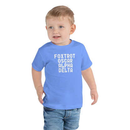 "Foxtrot Oscar Alpha Delta" printed on a heather columbia blue toddler short sleeve tee worn by a male