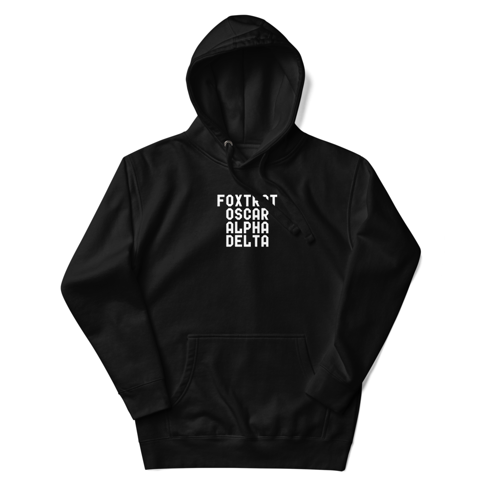 "Foxtrot Oscar Alpha Delta" printed on a black unisex hoodie laying on a flat surface with the hood up