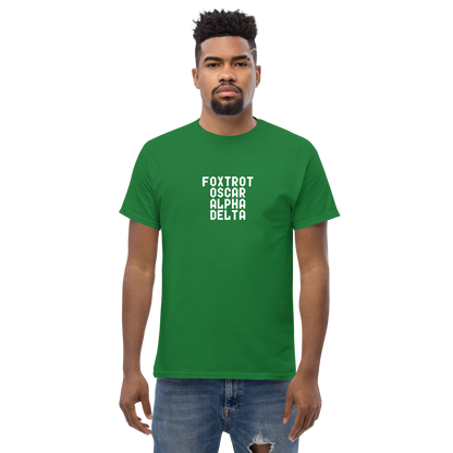 "Foxtrot Oscar Alpha Delta" printed on a turf green unisex classic tee worn by a male