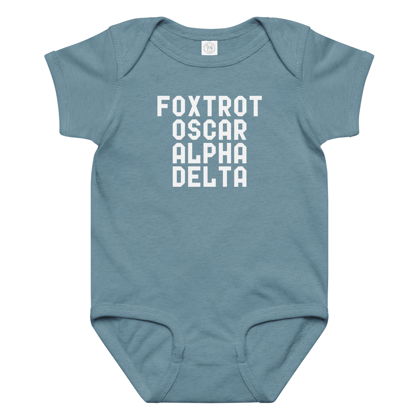 "Foxtrot Oscar Alpha Delta" printed on a vintage indigo baby jersey bodysuit laying on a flat surface amongst other clothes