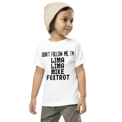 "Don’t follow me, I'm Lima Lima Mike Foxtrot" printed on a white toddler short sleeve tee worn by a male wearing a cap