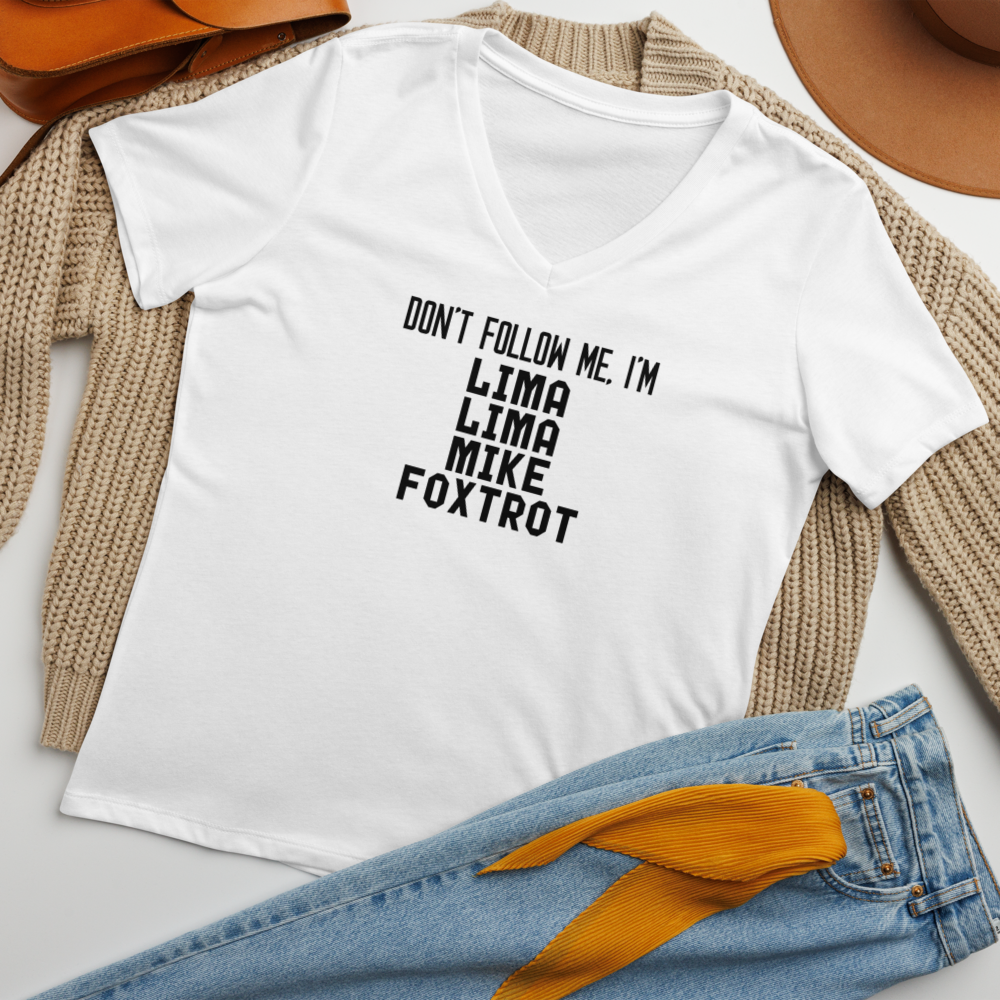 "Don’t follow me, I'm Lima Lima Mike Foxtrot" printed on a solid white blend women's relaxed v-neck t-shirt laying on a flat surface amongst other clothes