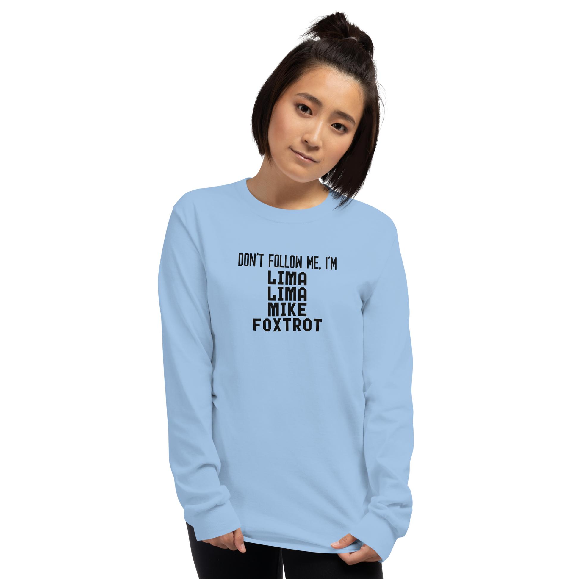 "Don’t follow me, I'm Lima Lima Mike Foxtrot" printed on a light blue men's long sleeve shirt worn by a female