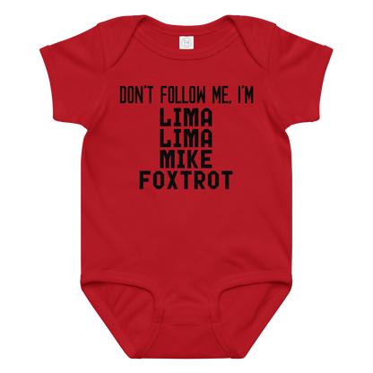 "Don’t follow me, I'm Lima Lima Mike Foxtrot" printed on a red baby jersey bodysuit laying on a flat surface amongst other clothes