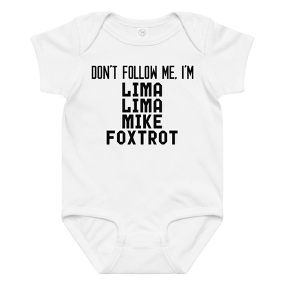 "Don’t follow me, I'm Lima Lima Mike Foxtrot" printed on a white baby jersey bodysuit laying on a flat surface amongst other clothes