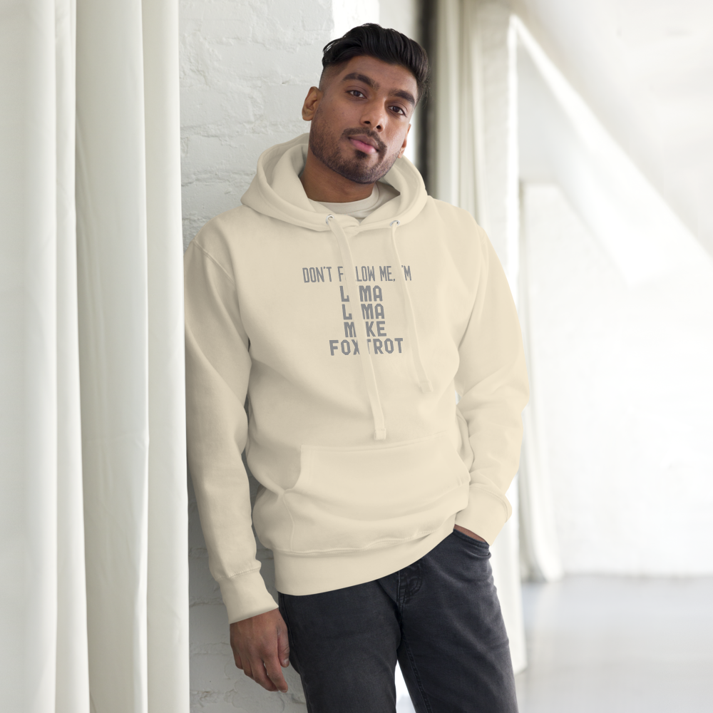 "Don’t follow me, I'm Lima Lima Mike Foxtrot" printed on a bone unisex hoodie worn by a male