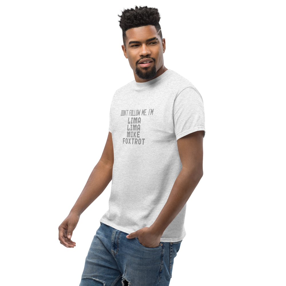 "Don’t follow me, I'm Lima Lima Mike Foxtrot" printed on a ash unisex classic tee worn by a male