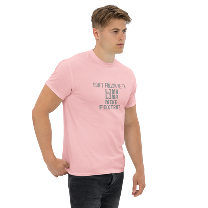 "Don’t follow me, I'm Lima Lima Mike Foxtrot" printed on a light pink unisex classic tee worn by a male