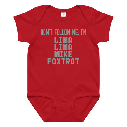 "Don’t follow me, I'm Lima Lima Mike Foxtrot" printed on a red baby jersey bodysuit laying on a flat surface amongst other clothes