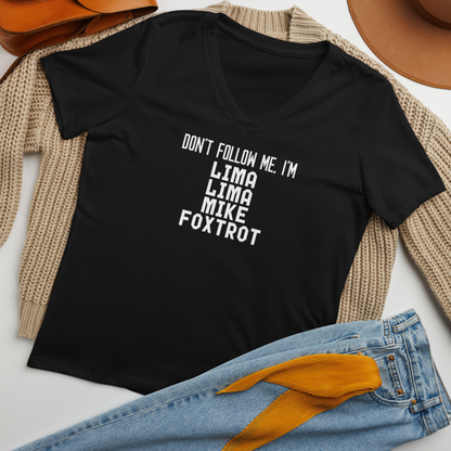 "Don’t follow me, I'm Lima Lima Mike Foxtrot" printed on a solid black blend women's relaxed v-neck t-shirt laying on a flat surface amongst other clothes