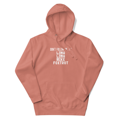 "Don’t follow me, I'm Lima Lima Mike Foxtrot" printed on a dusty rose unisex hoodie laying on a flat surface with the hood up