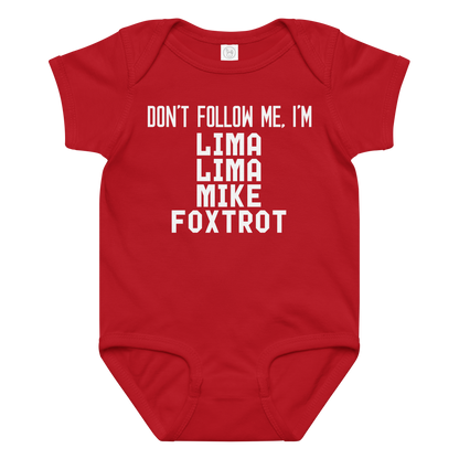 "Don’t follow me, I'm Lima Lima Mike Foxtrot" printed on a red baby jersey bodysuit laying on a flat surface amongst other clothes