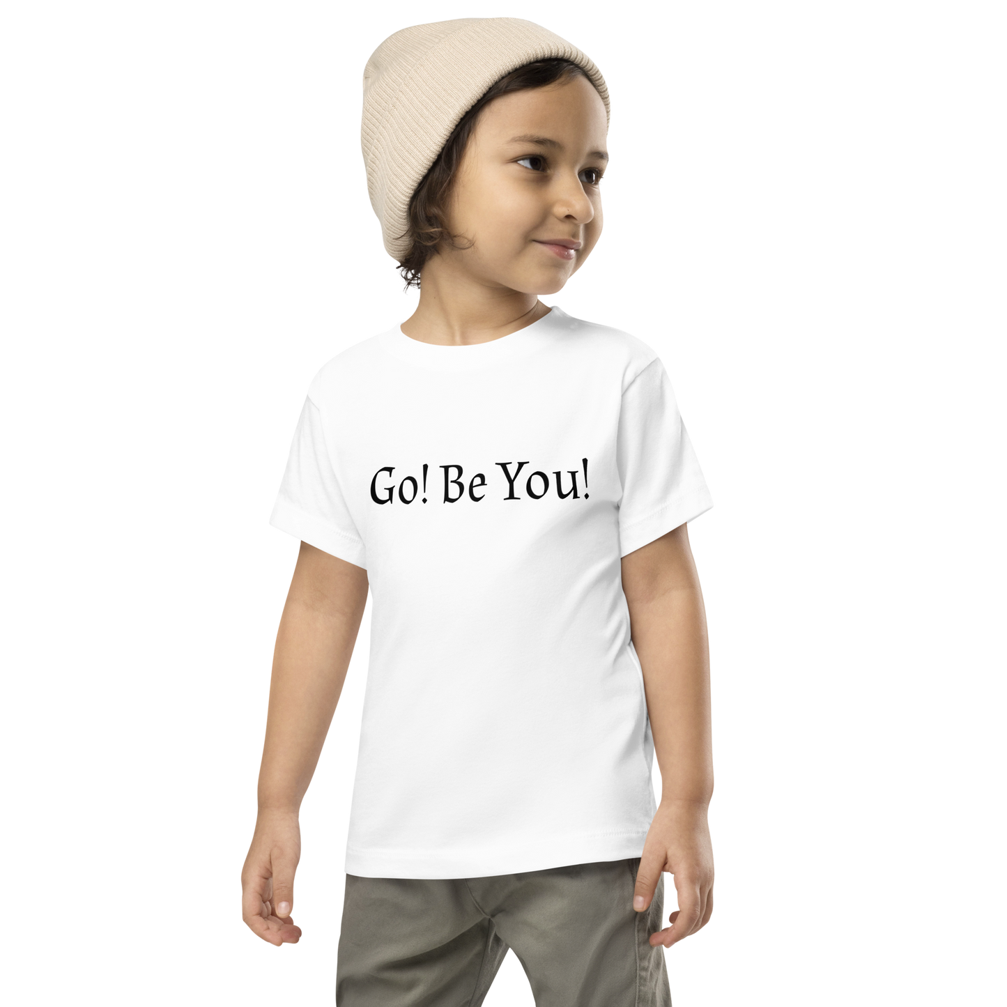 "Go! Be You!" printed on a white toddler short sleeve tee worn by a male wearing a cap