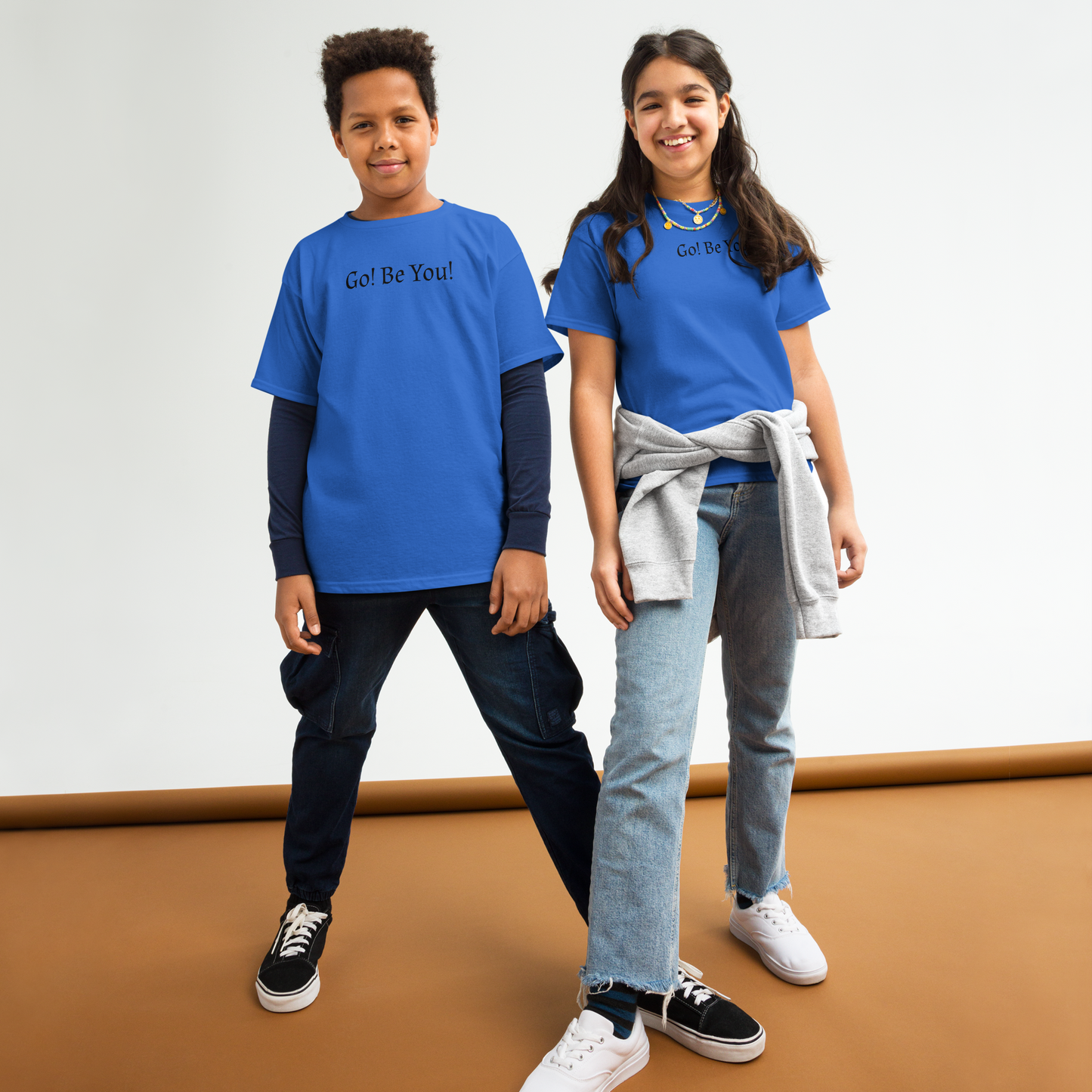 "Go! Be You!" printed on a royal youth classic tee worn by a female and male