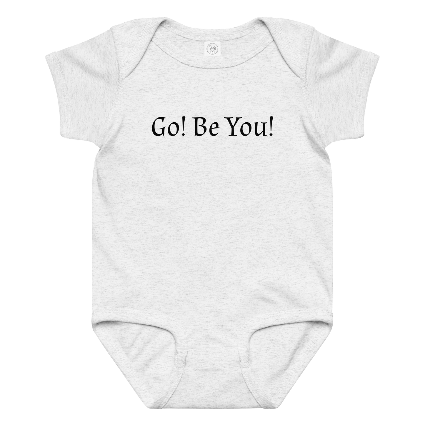 "Go! Be You!" printed on a ash baby jersey bodysuit laying on a flat surface amongst other clothes
