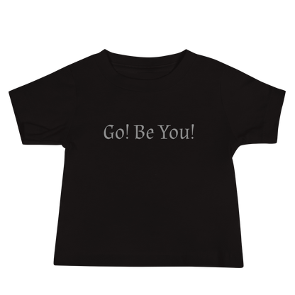 "Go! Be You!" printed on a black baby jersey short sleeve tee laying on a flat surface