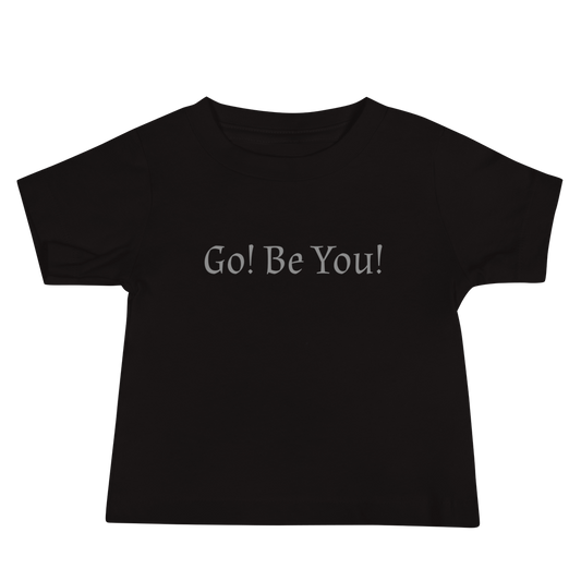 "Go! Be You!" printed on a black baby jersey short sleeve tee laying on a flat surface