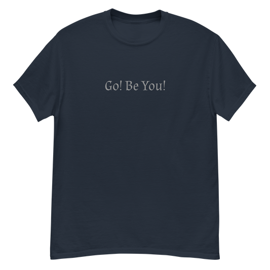 "Go! Be You!" printed on a navy unisex classic tee laying on a flat surface