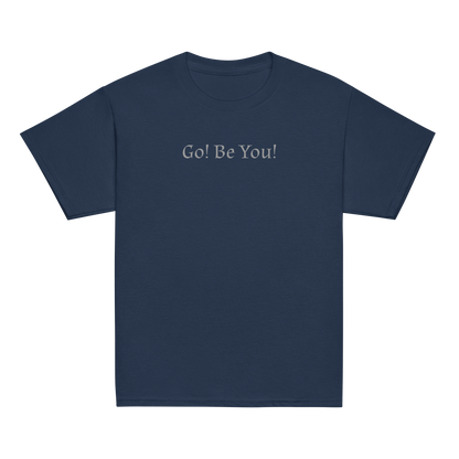 "Go! Be You!" printed on a navy youth classic tee laying on a flat surface