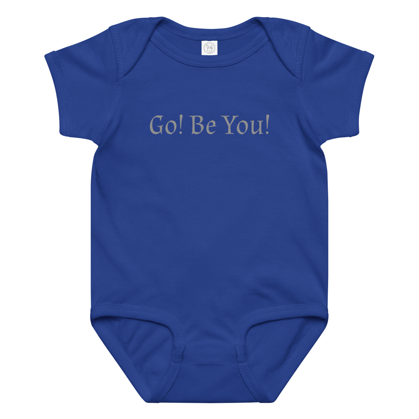 "Go! Be You!" printed on a royal baby jersey bodysuit laying on a flat surface amongst other clothes