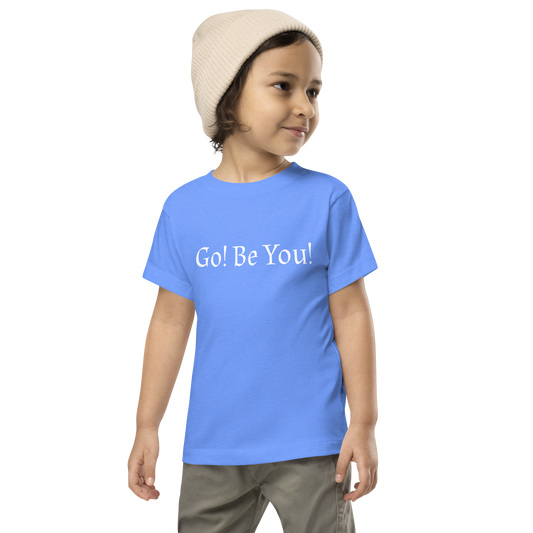 "Go! Be You!" printed on a heather columbia blue toddler short sleeve tee worn by a male wearing a cap
