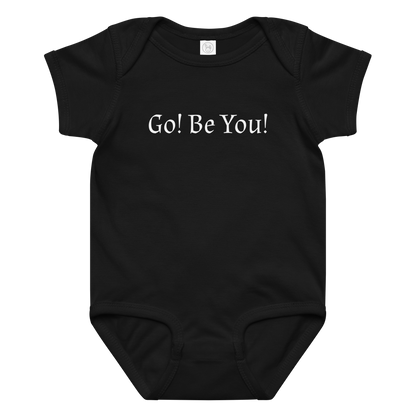 "Go! Be You!" printed on a black baby jersey bodysuit laying on a flat surface amongst other clothes