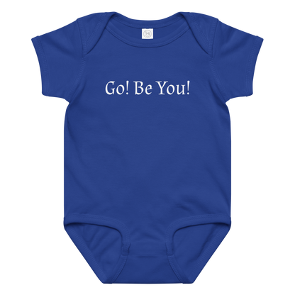 "Go! Be You!" printed on a royal baby jersey bodysuit laying on a flat surface amongst other clothes