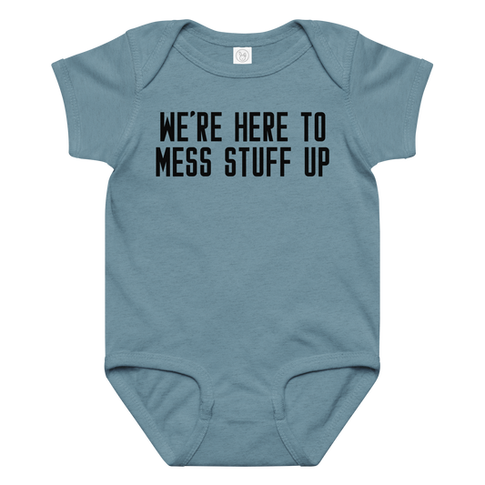 "We're Here To Mess Stuff Up" printed on a vintage indigo baby jersey bodysuit laying on a flat surface amongst other clothes