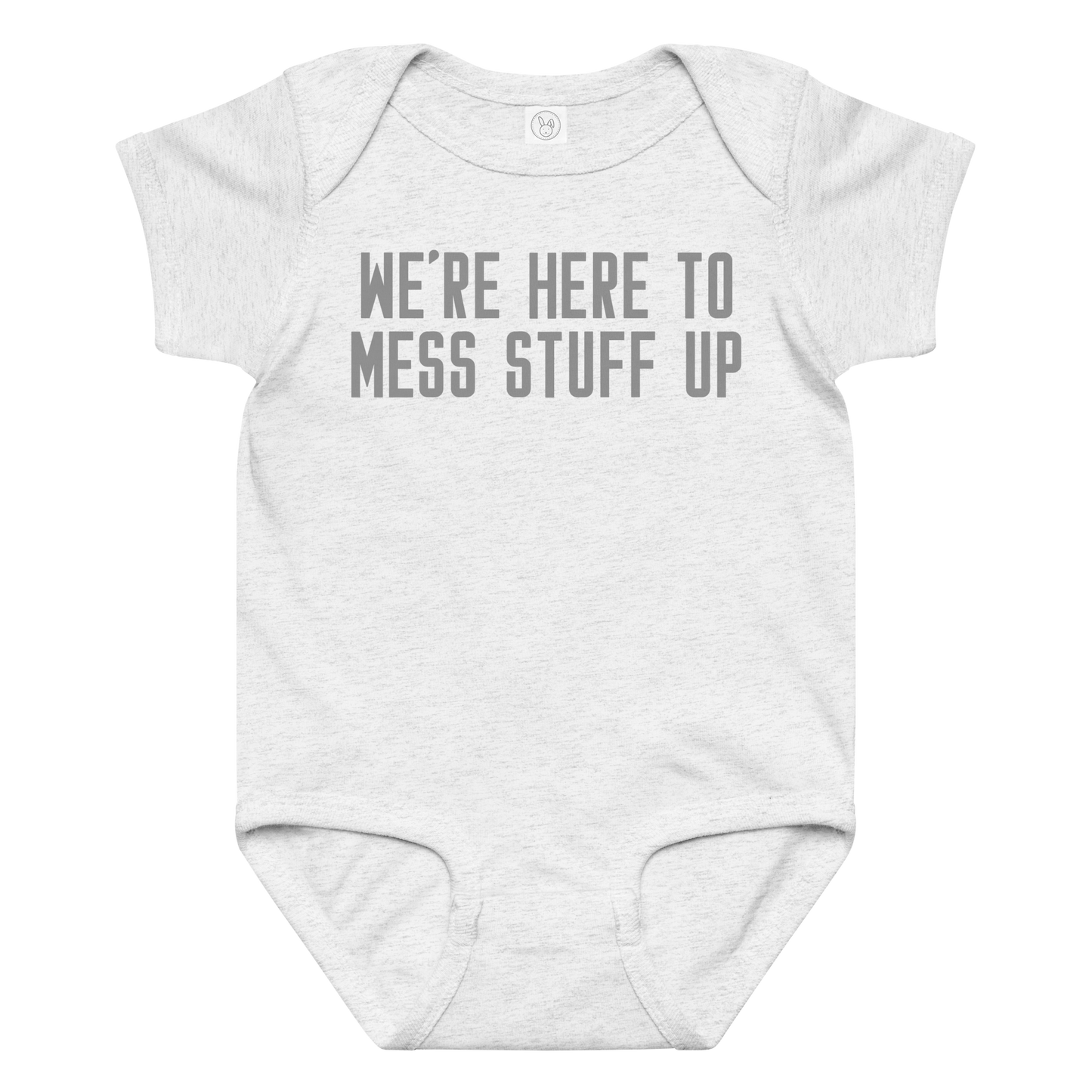 "We're Here To Mess Stuff Up" printed on a ash baby jersey bodysuit laying on a flat surface amongst other clothes
