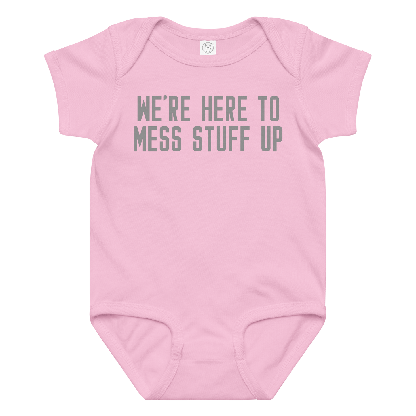 "We're Here To Mess Stuff Up" printed on a pink baby jersey bodysuit laying on a flat surface amongst other clothes