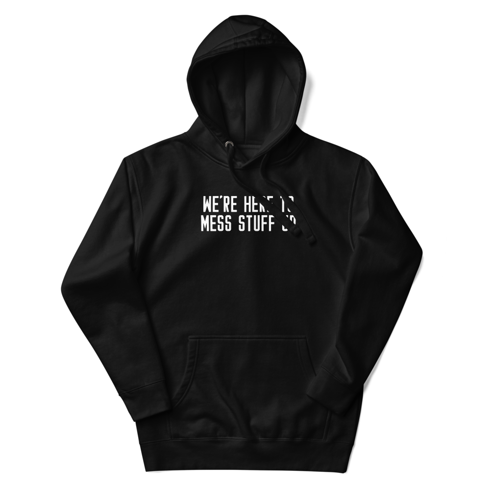 "We're Here To Mess Stuff Up" printed on a black unisex hoodie laying on a flat surface with the hood up