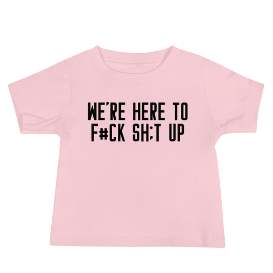 "We're Here To F#Ck Sh:t Up" printed on a pink baby jersey short sleeve tee laying on a flat surface