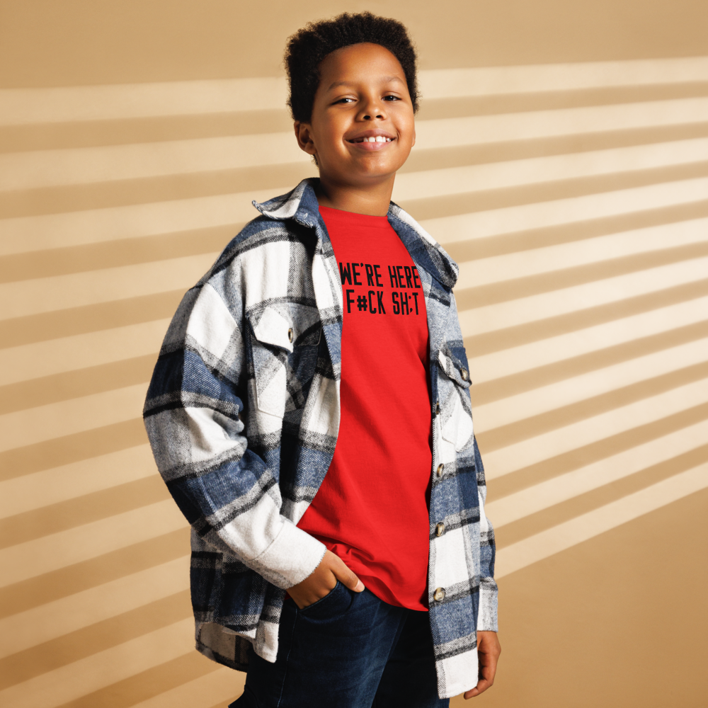 "We're Here To F#Ck Sh:t Up" printed on a red youth classic tee worn by a male also wearing a jacket