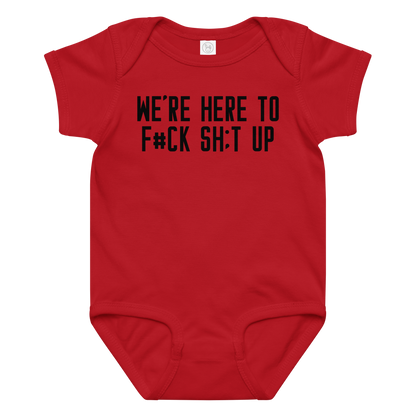 "We're Here To F#Ck Sh:t Up" printed on a red baby jersey bodysuit laying on a flat surface amongst other clothes